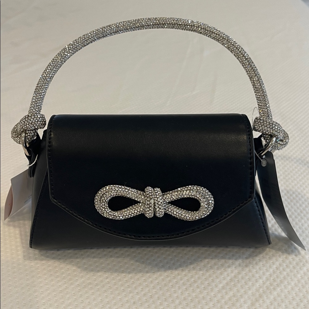 Black pocketbook/tote with knotted crystal handle and crystal bow detail.